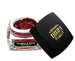 Product shot of Elektra Cosmetics Crimson Kiss Bolt Balm in an open clear jar filled with vibrant chunky red and gold glitter, beside a black lid featuring the bold gold Elektra Cosmetics logo