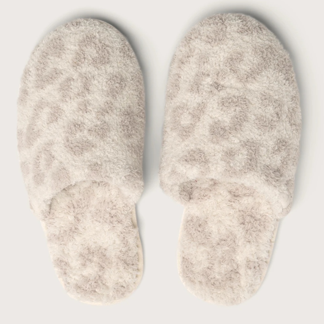 cream and taupe cheetah print slippers on a white background