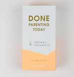 Product image by Chez Gagné showing a white and orange box of eight orange vanilla shower steamers with bold gold text reading DONE PARENTING TODAY