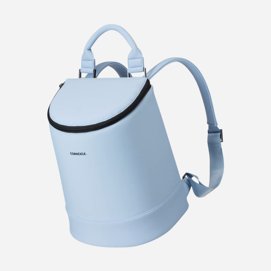 Corkcicle product photography showing a baby blue backpack with a black zipper, curved top handle, and adjustable straps