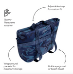 A Corkcicle neoprene tote bag in a blue camouflage pattern featuring an adjustable strap wrap-around pockets and design for holding a yoga mat or beach towel
