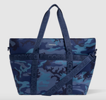 CORKCICLE cooler tote bag featuring a blue camouflage pattern with branded CORKCICLE webbing handles and a removable matching shoulder strap
