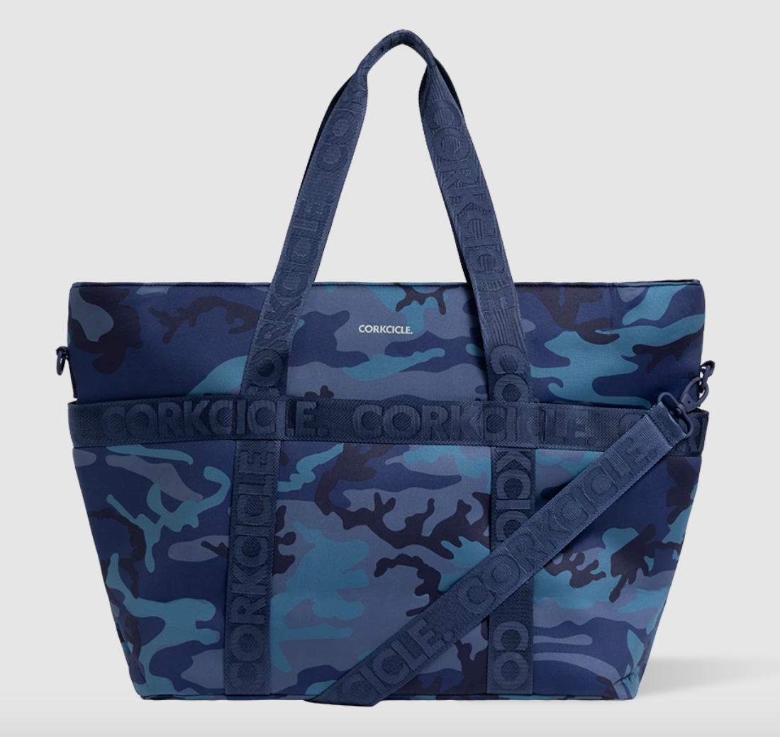 CORKCICLE cooler tote bag featuring a blue camouflage pattern with branded CORKCICLE webbing handles and a removable matching shoulder strap