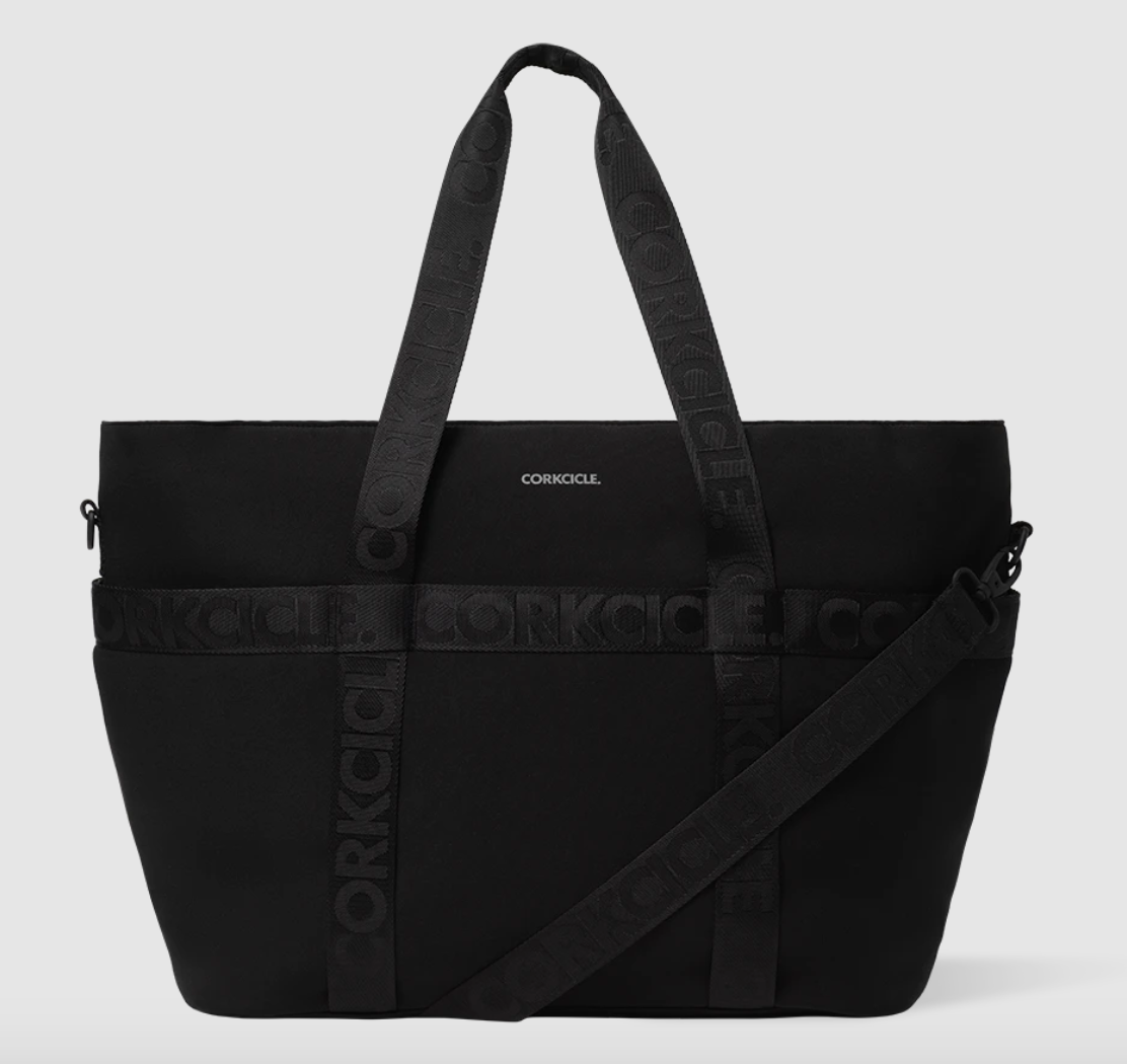 CORKCICLE product photography of a sleek matte black tote bag featuring the CORKCICLE logo prominently on the front and repeating embossed text on its two top handles and detachable cross-body strap