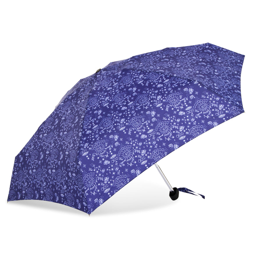 Photograph of an open vibrant blue umbrella showcasing an intricate white pattern of suns stars and abstract floral shapes