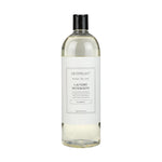 Archipelago Laundry Detergent bottle on a white background, featuring a clear liquid, a black pour-spout cap, and a minimalist white label with Archipelago branding and plant-based classic scent details