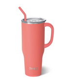 Product image by Swig featuring a coral pink insulated tumbler with a silicone straw, clear lid, and side handle, displaying the silver Swig logo on a white background