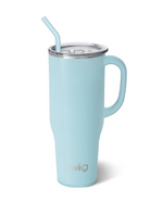 Product photograph by Swig of a pale blue insulated tumbler featuring a large matching handle, a clear lid with a bent straw, and a metallic Swig logo