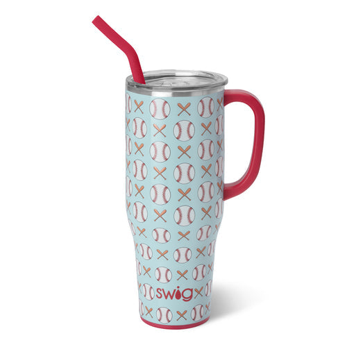 Swig Life insulated tumbler with a light blue background featuring a repeating pattern of baseballs and crossed bats, accented by a vibrant red handle, a matching red reusable straw, and the Swig logo