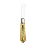 A shiny stainless steel butter spreader featuring a silver ferrule and a faceted metallic gold handle