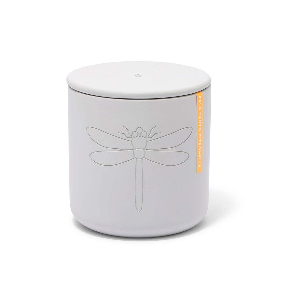 White ceramic candle jar with lid featuring an embossed dragonfly design and an orange Palo Santo Citronella label