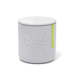 Light grey cylindrical candle or diffuser with a matching lid, featuring an embossed mosquito design and a bright green label reading Verbena Citronella on a white background
