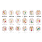 Grid of colorful enamel alphabet letter pendants on gold chains
