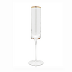 Clear glass champagne flute with a tall slender stem a small round base and a delicate gold rim on a white background