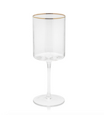 Clear glass modern stemmed drinking glass featuring a gold rim a vertically ribbed cylindrical bowl and a slender stem on a white background