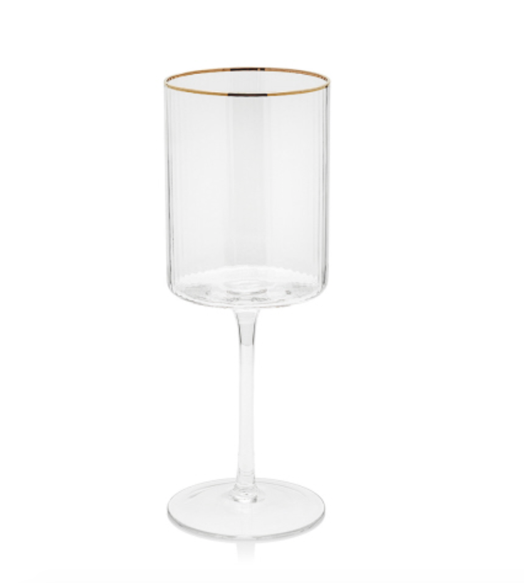 Clear glass modern stemmed drinking glass featuring a gold rim a vertically ribbed cylindrical bowl and a slender stem on a white background