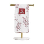 White kitchen towel with a red lobster outline pattern and a PEEL EAT REPEAT tag displayed on a brass and marble stand