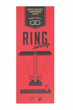 Product packaging for Gentlemen's Hardware featuring a vibrant red background with a black and gold top label for Games Supply, illustrating a black outline of a 'RING swing' game with wooden construction for two players