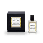 Saint African Sandalwood perfume bottle and its black box both featuring white labels with gold borders and bold black text on a crisp white background