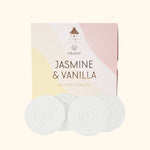 Product photograph by Musee showing Jasmine & Vanilla Shower Steamers in a pastel pink and yellow wavy box featuring a showerhead icon, alongside four white circular steamers with an embossed leaf logo