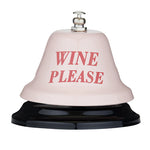 Metal novelty bell featuring a pale pink dome with bold red text WINE PLEASE a shiny silver press button and a glossy black base