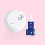 pura smart diffuser with 2 blue capri blue volcano refills on a pink background